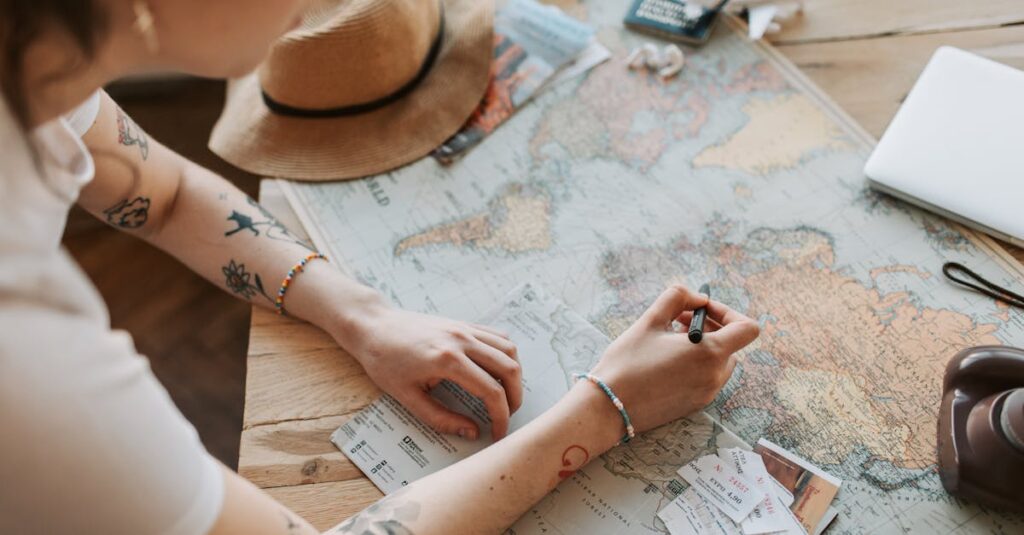 Person planning a journey with a map, passport, and travel essentials on a wooden table.