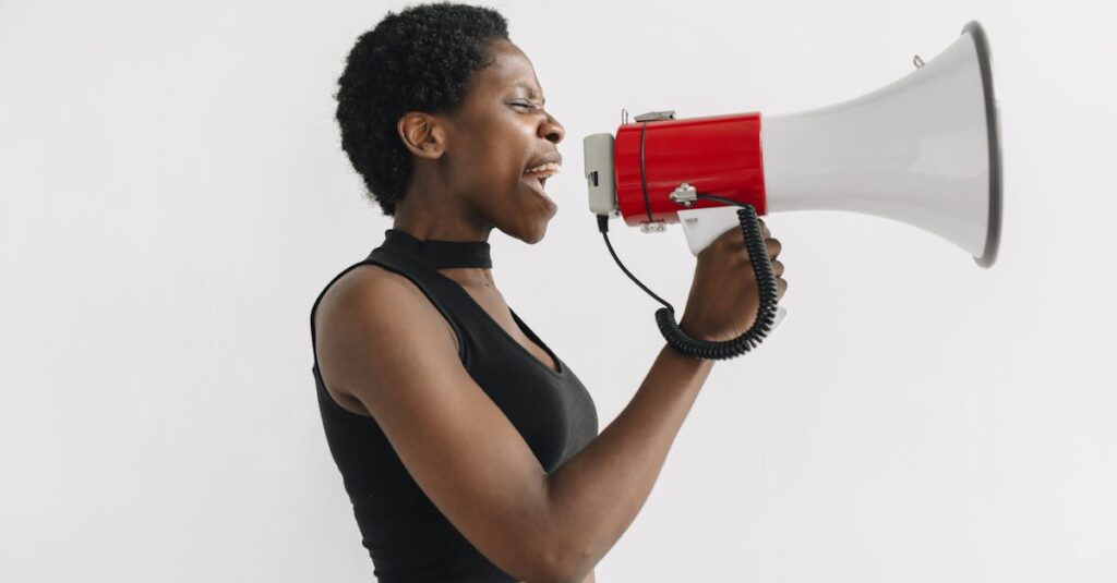African American woman using a megaphone to protest, symbolizing activism and empowerment.
