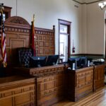 Interior view of an American courthouse in Kirksville, Missouri, featuring a judge's desk and flags.