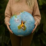 A woman holding a burning globe depicting Australia's climate crisis.
