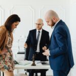 A lawyer meets with clients to discuss legal matters in a professional office setting.