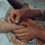 A healthcare professional administers an injection to an elderly patient in a hospital setting.